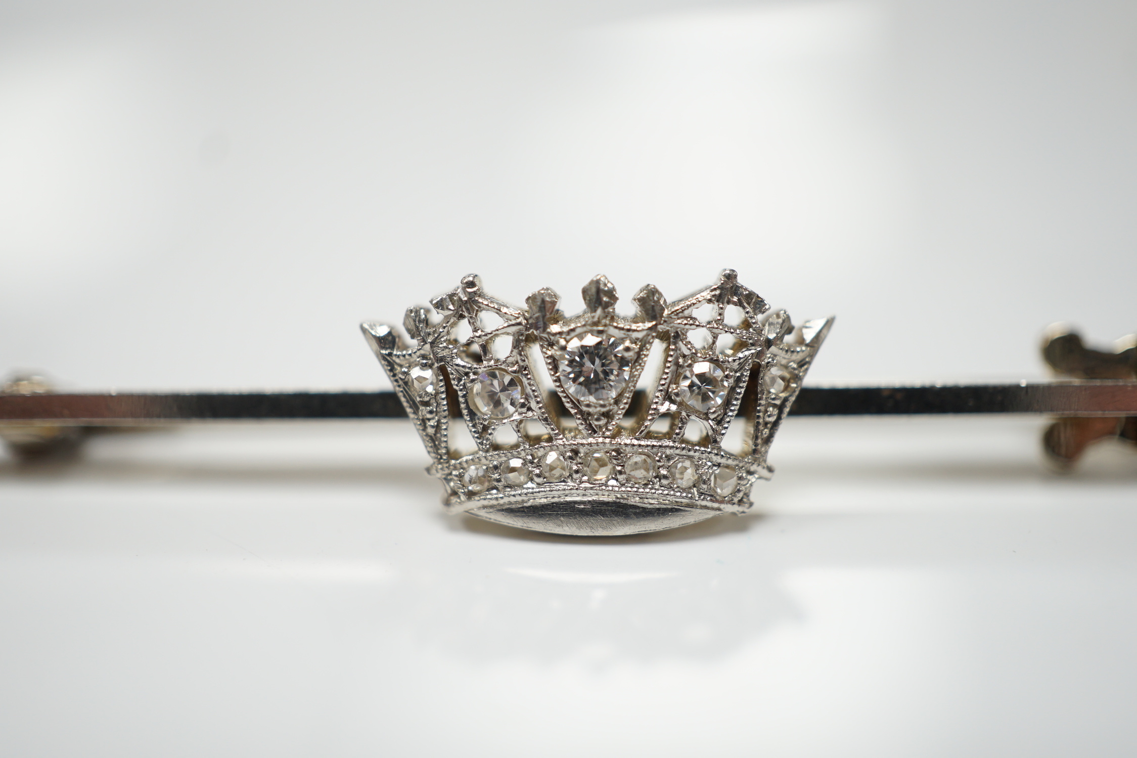 A 1940's white metal (stamped 14ct and platinum) and diamond cluster set coronet bar brooch, 50mm, gross weight 4.1 grams.